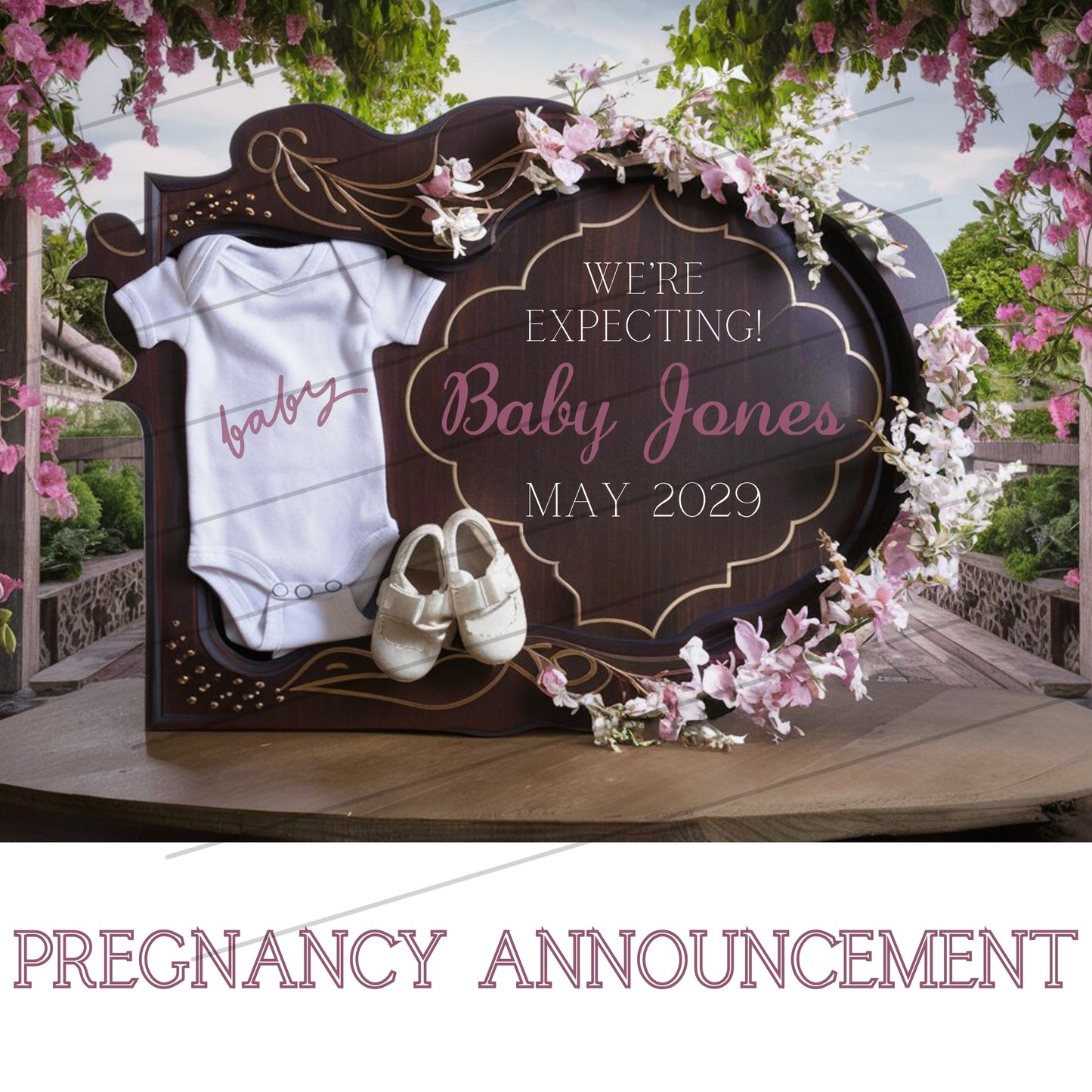Pregnancy announcement sign with baby onesie and shoes, set against a floral backdrop.