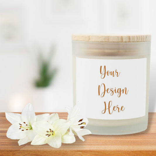 Candle with a customizable label on a wooden surface with white flowers.