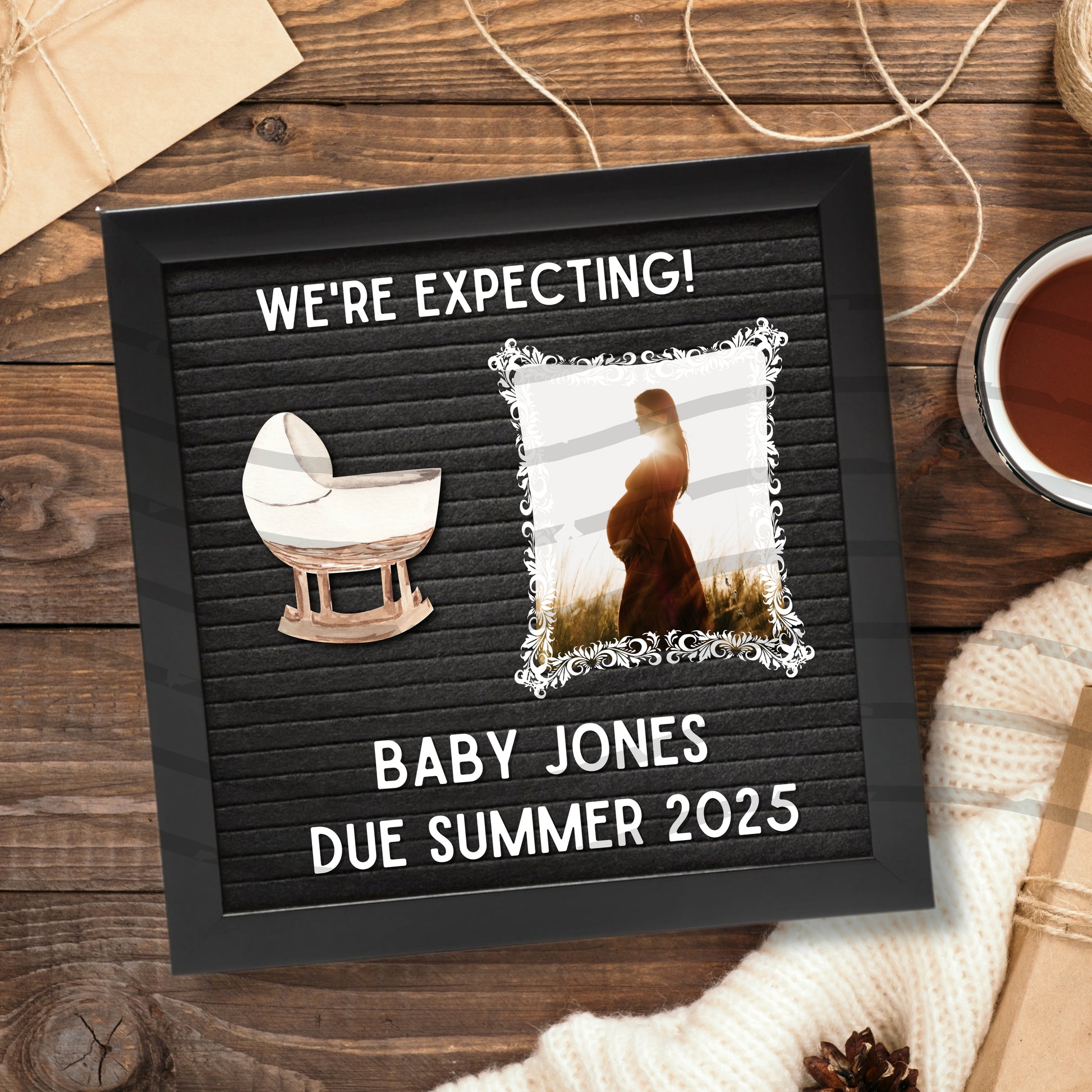 Felt letter board with pregnancy announcement on a wooden surface