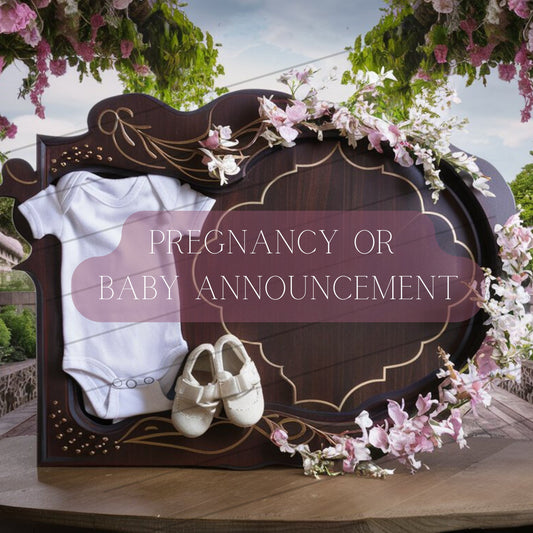 Decorative baby announcement sign with a onesie and shoes on a floral arch.