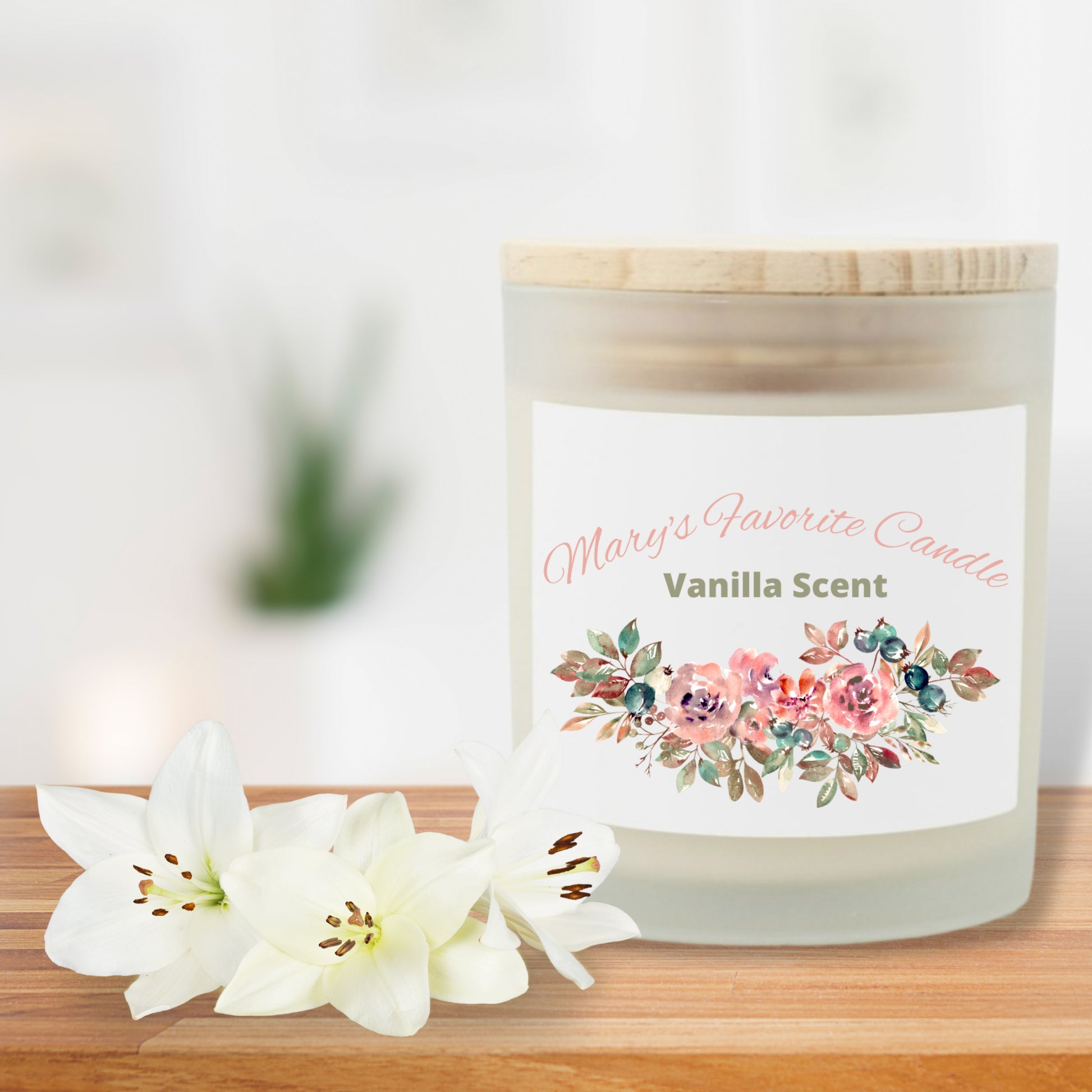 Candle with floral label on a wooden surface with white flowers