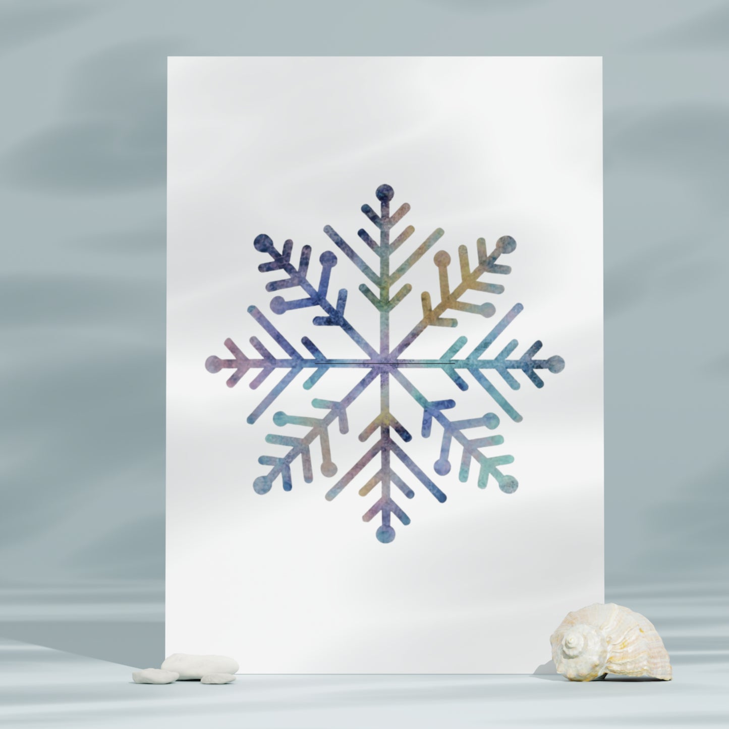 Colorful snowflake design on a white card with seashells on a gray background