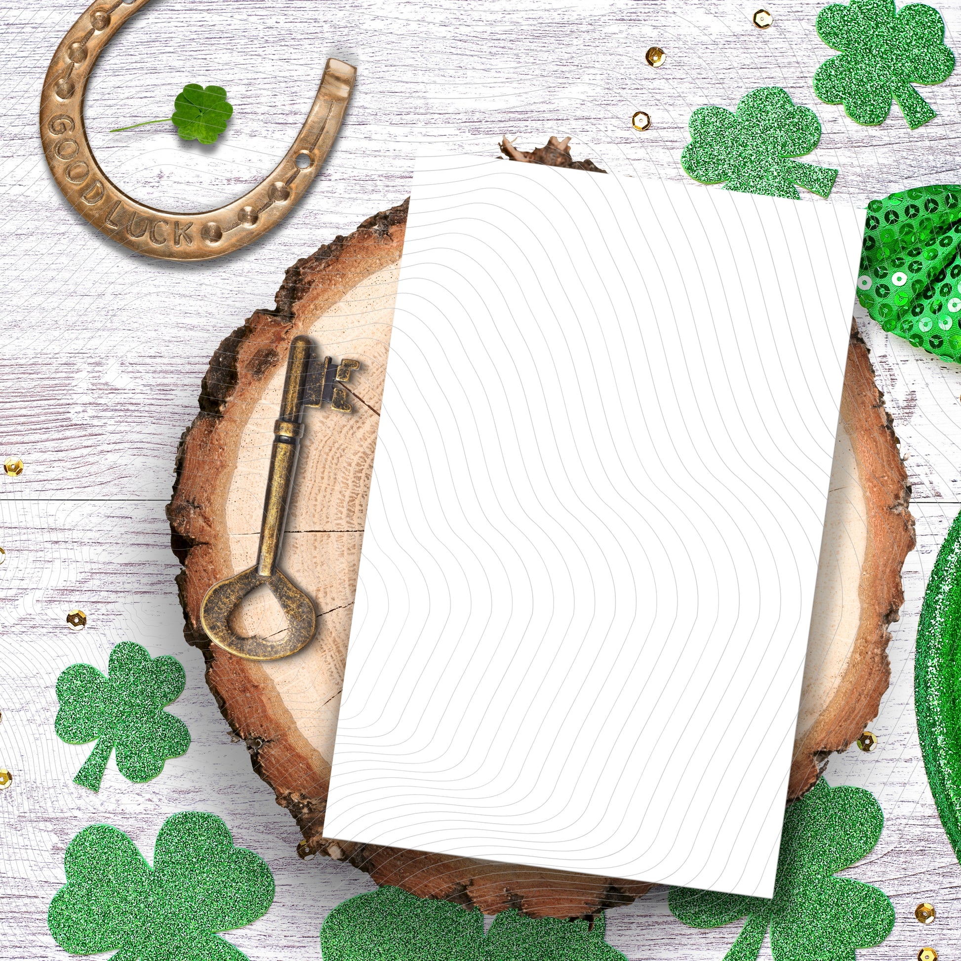 Note paper on a wooden surface with shamrocks and a horseshoe, likely for St. Patrick's Day.